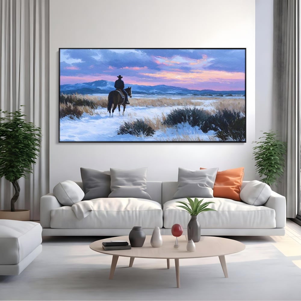 Tablou canvas cu pictura cu calaret cowboy in zapada, in rama de aluminiu negru, pe perete intr-un living